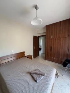 a bedroom with a bed and wooden cabinets at Relaxivng home 2 in Konístrai
