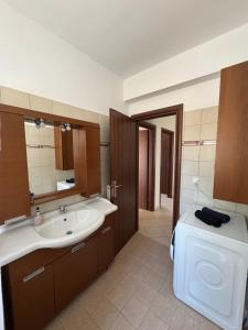 a bathroom with a sink and a toilet at Relaxivng home 2 in Konístrai +9 photos