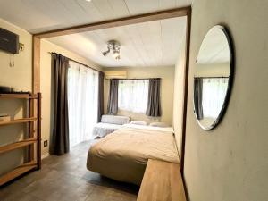 a bedroom with a bed and a mirror in it at Forest 99 in Nasushiobara