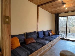 a large blue couch in a room with a window at Forest 99 in Nasushiobara