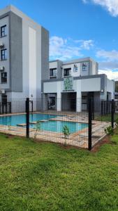 a building with a swimming pool in front of a building at Minnestayairbnb in Gaborone