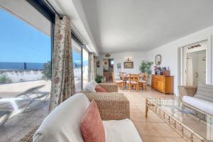 a living room with a view of the ocean at Bungalow Olas del Risco - Ocean views - Beach 2 min By Lanzarote Vacation Homes in Famara +49 photos