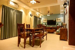 a dining room with a table and chairs and a television at Serenity by the Sea Goa in Silidao