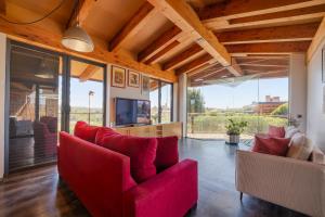 a living room with red furniture and large windows at Flateli Palau 1 in Girona