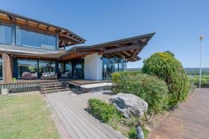a home with a wooden walkway and a house at Flateli Palau 1 in Girona