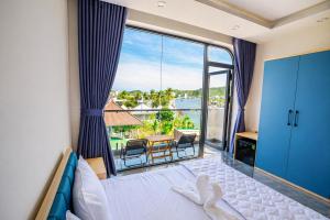 a bedroom with a bed and a view of the ocean at Đức Loan Hotel Vĩnh Hy in Ninh Hải +36 photos