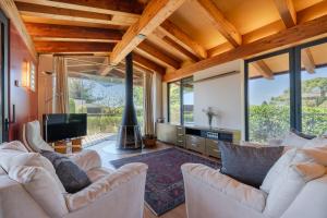 a living room with two white couches and a tv at Flateli Palau 2 in Girona