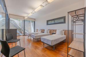 a hospital room with two beds and a chair at Flateli Palau 2 in Girona +39 photos