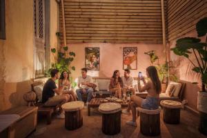 a group of people sitting in a living room at Baloo Hostel in Athens