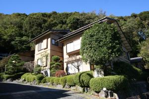 a house with bushes in front of it at Hoshi Meguri in Shimoda