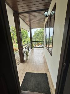 a hallway of a house with a porch with windows at Wind Bells in Anaviratty +14 photos