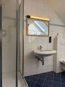 a bathroom with a sink and a mirror and a shower at Ferienhaus Christine Bauer in Hintergöriach