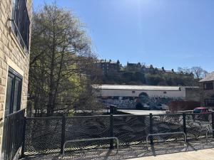 a fence in front of a building with a castle in the background at Smithy Mills in Halifax