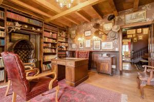 a library with a desk and a chair and books at Portland Manor in Knysna