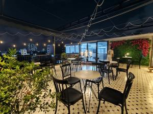 a patio with tables and chairs in a restaurant at Danang's house in Danang