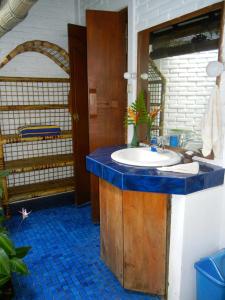 a bathroom with a sink with a blue counter top at Tirtagangga Water Palace Villas in Tirtagangga