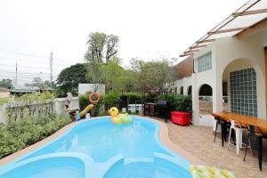 a swimming pool in the backyard of a house at Chiang Mai Private "Davin Pool Villa" CNX 2km to Central Festival in Chiang Mai