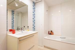 a bathroom with a sink and a tub and a mirror at Patacona By The Beach in Valencia +17 photos