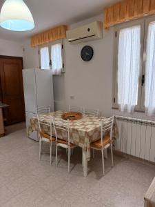 a kitchen with a table and chairs and a refrigerator at La Puteca di Nonna Cia in Andrano +15 photos