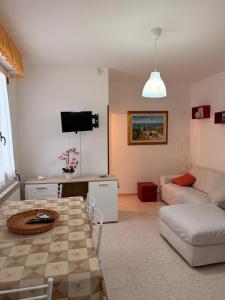 a living room with a couch and a table at La Puteca di Nonna Cia in Andrano