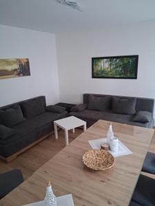 a living room with a couch and a table at Ferienanlage - Am Moselufer in Kövenig