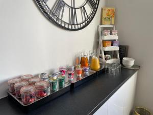 a counter with jars of food and a clock on the wall at Dolly Waggon Guest House in Keswick