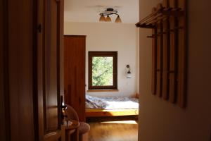 a bedroom with a small bed and a window at Pensjonat EL-TAN - nocleg na wsi z WI-FI bez TV in Złoty Stok