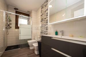 a bathroom with a sink and a toilet and a shower at Pomar By Silastur in Obaya +29 photos