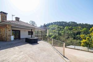 a house with a balcony with a view of the forest at Pomar By Silastur in Obaya