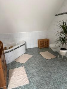 a bathroom with a tub and a toilet and a sink at Haus Erika in Gamlitz