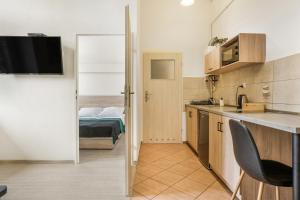 a small apartment with a kitchen and a bedroom at Apartament Pierwszy Maj in Kudowa-Zdrój +5 photos