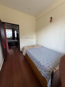 a bedroom with a bed and a window at Adhikari mountain view homestay in Chaubattia +3 photos
