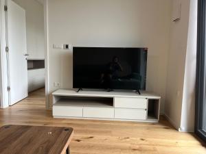 a flat screen tv sitting on a white entertainment center at TB7 Sg in Slovenj Gradec
