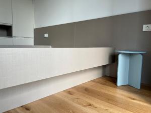 a counter with a blue stool in a room at TB7 Sg in Slovenj Gradec