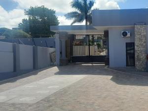 a white house with a gate and a fence at San D- Lux Boutique Hotel in Durban +9 photos