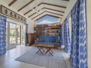 a living room with a blue couch and a table at M4R 03 Villa Maracanda, Banyalbufar in Banyalbufar