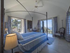 a bedroom with a blue bed and a balcony at M4R 03 Villa Maracanda, Banyalbufar in Banyalbufar +45 photos