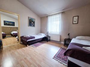 a bedroom with two beds and a large mirror at Hotel Komfort Inn - Dwór Hubertus in Piekary Śląskie