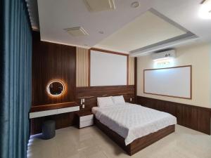 a bedroom with a bed and a blank screen at Viet Trung Hotel in Nhơn Trạch