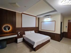 a bedroom with a bed and a projection screen at Viet Trung Hotel in Nhơn Trạch