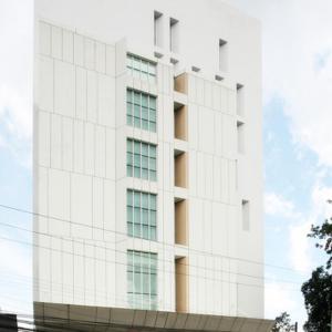 a white building with glass windows at Wyne Hotel in Yangon