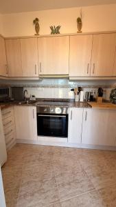 a kitchen with white cabinets and a black oven at Peniscola Bella in Peniscola +4 photos