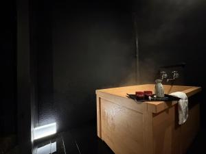 a bathroom with a wooden counter with a sink at Senbonzakura Yoshino in Yoshino