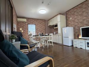 a kitchen and living room with a white refrigerator at Senbonzakura Yoshino in Yoshino