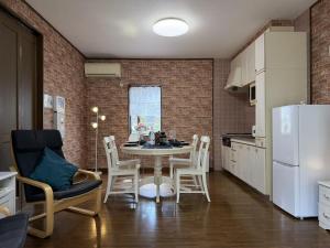 a kitchen with a table and chairs in a room at Senbonzakura Yoshino in Yoshino +13 photos