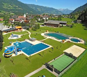 an aerial view of two swimming pools and a tennis court at Appartement Wurm- nahe Hochzillertal für Familien in Kaltenbach