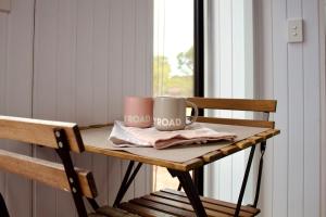 two coffee mugs sitting on a table in a room at Hill River Nature Reserve by Tiny Away in Jurien Bay