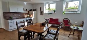 a kitchen and dining room with a wooden table and chairs at Rheinufer in Xanten