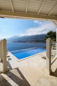 a swimming pool with a view of the water at Villa Alis stunning sea view with Infinity Pool in Kaş