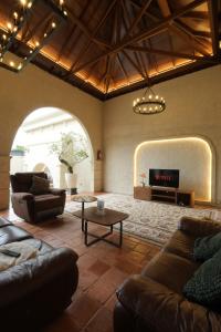 a living room with two couches and a tv at Princessa Villa by Raminten in Pakem